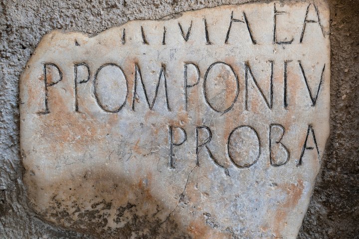 latin writing in white stone